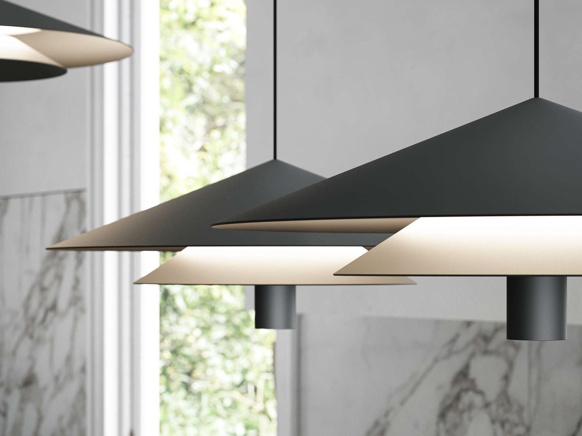 A close-up look at the Asso pendant light. With its matte black finish and graphic, layered silhouette, this modern light adds quiet drama to kitchens and dining spaces. A perfect blend of minimalism and warmth.
