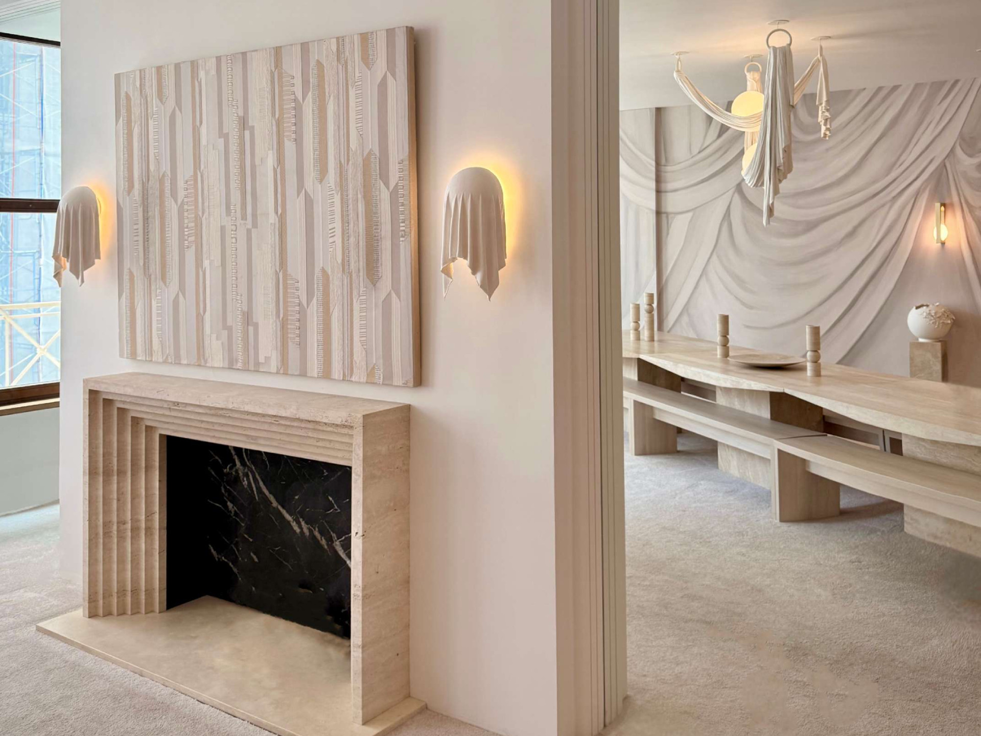 The Requiem Wall Light, handcrafted in plaster using a unique sculpting technique, captures the fluidity of draped fabric in a striking wall-mounted form.